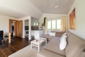 a living room with a couch and a table at Steinrüti in Wildhaus