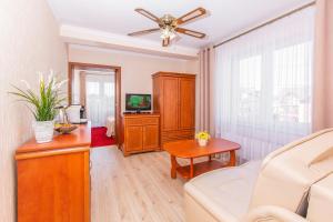 a living room with a couch and a ceiling fan at Rades in Władysławowo