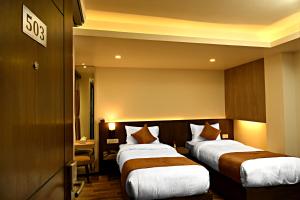 Ένα ή περισσότερα κρεβάτια σε δωμάτιο στο The Milestone Hotel