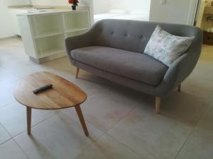 a living room with a couch and a coffee table at Apartamentos Villa Primera in Cala Figuera