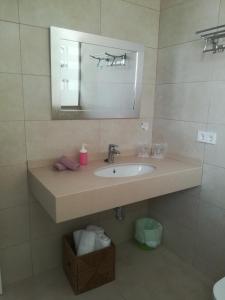 a bathroom with a sink and a mirror at Apartamentos Villa Primera in Cala Figuera