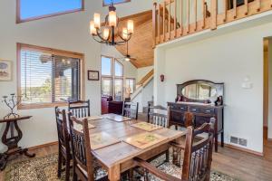 a dining room with a wooden table and chairs at Pine Vista in Pagosa Springs