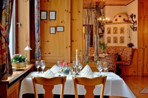 a table with wine glasses and a candle on it at Gasthof & Landhotel Ohrnbachtal in Weilbach