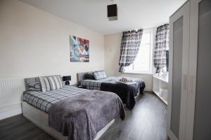 a bedroom with two beds and a window at Dunes Hotel in Whitley Bay