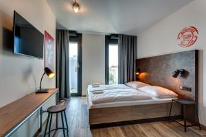 Postel nebo postele na pokoji v ubytování MEININGER Hotel Berlin Tiergarten