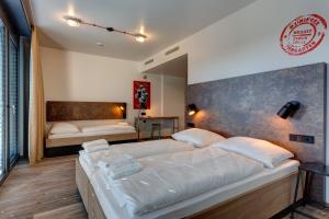 Postel nebo postele na pokoji v ubytování MEININGER Hotel Berlin Tiergarten