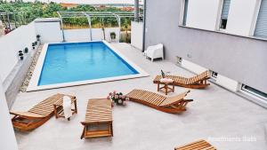 an overhead view of a patio with a swimming pool at Salis Apartments in Vrsi
