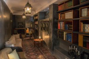 a living room with bookshelves and a couch at Riad Yamina in Marrakesh