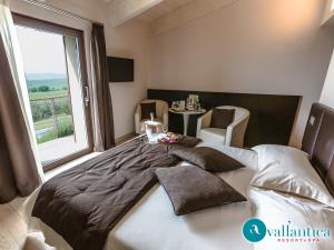 a bedroom with a large bed with a large window at Vallantica Resort & SPA in San Gemini