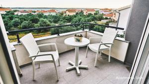 a balcony with a table and chairs and a view at Salis Apartments in Vrsi