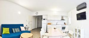 a living room with a blue couch and a table at Salis Apartments in Vrsi