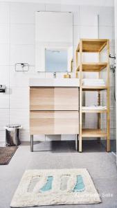 a bathroom with a sink and a mirror at Salis Apartments in Vrsi