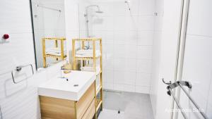 a bathroom with a sink and a shower at Salis Apartments in Vrsi