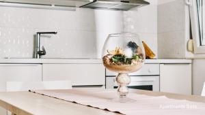 a wine glass with a fish in it on a kitchen counter at Salis Apartments in Vrsi