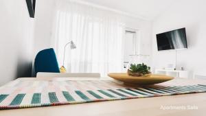 a dining room table with a bowl on top of it at Salis Apartments in Vrsi