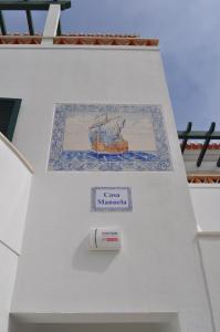 a painting of a ship on the side of a building at Casa Manuela in Ericeira