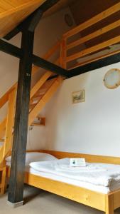 A bed or beds in a room at Penzión Manín