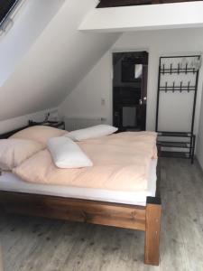 a bedroom with a bed with white sheets and pillows at Lavendelhof Elsdorf in Elsdorf