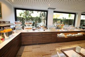 a buffet line with cakes and desserts on display at Hotel Domenichino in Milan
