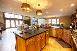a large kitchen with wooden cabinets and a large island at Seesaw's Lodge in Peru