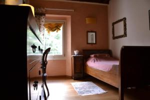 a bedroom with a bed and a window at Alla Locanda Del Cinquecento in Castrocaro Terme