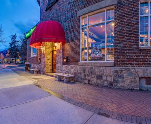 a brick building with a bench in front of it at Athabasca Hotel in Jasper