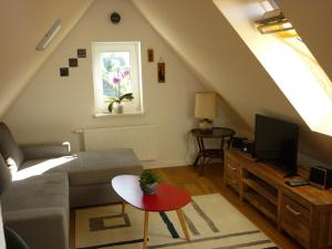 a living room with a couch and a tv at Ferienhaus Kozian in Kühlungsborn