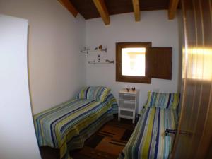 a bedroom with two twin beds and a mirror at 1g CASA DE LOS FERNANDEZ RAJO in Orihuela del Tremedal