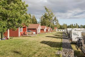 a yard with a row of houses and a parked rvs at Askeviks Camping & Stugor in Sjötorp