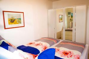 a small bedroom with two beds and a mirror at Koserow_Jugendweg_FeWo 13 in Ostseebad Koserow