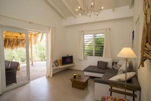 a living room with a couch and a tv at Appartement Kas Wahoo at Sabal Palm Villas in Kralendijk