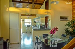 a kitchen and dining room with a table and chairs at Casa de beira mar com piscina in Coruripe