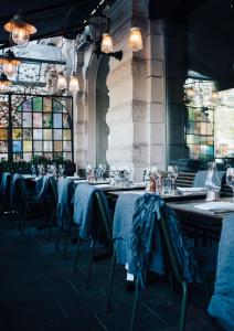 a row of tables with blue table cloths on them at Elite Hotel Stockholm Plaza in Stockholm