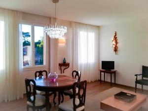a dining room with a table and chairs and a chandelier at Appartamento Rio de la Fornace in Venice