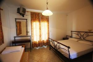 Postel nebo postele na pokoji v ubytování Hotel Rigakis