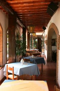 a dining room with two tables and chairs in a building at Agriturismo Manetti in Montespertoli