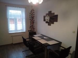 una sala da pranzo con tavolo, sedie e albero di Natale di Nowy Apartament w Centrum Włodawy a Włodawa
