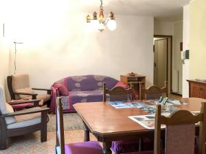 a living room with a table and a couch at House of cats in Domaso