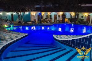a large swimming pool with blue water at night at Best Western Jangwani Sea Breeze Resort in Dar es Salaam