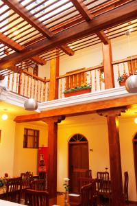 a dining room with wooden tables and chairs at Casa Hotel Las Plazas in Quito