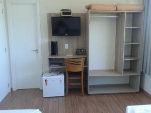 a room with a desk and a tv and a bunk bed at Dalle Hotel in Bagé
