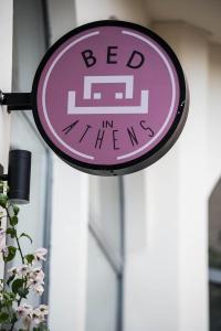 a sign with a clock on top of it at BED in Athens in Athens