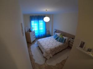 a small bedroom with a bed and a window at Sea & City in Leça da Palmeira