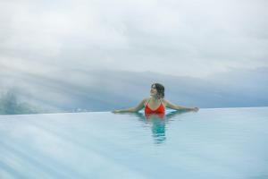 a woman in the water at the blue lagoon at Villa Vajrapani in Kandy