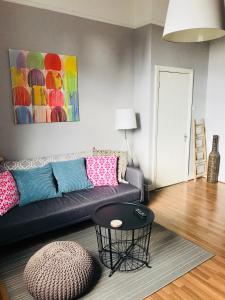 a living room with a couch and a table at City Centre Georgian Apartment in Dublin