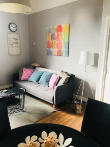 a living room with a couch with colorful pillows at City Centre Georgian Apartment in Dublin