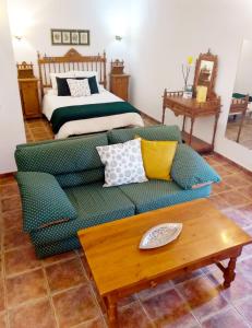 a living room with a couch and a bed at Hotel Palacio Buenavista in Belmonte