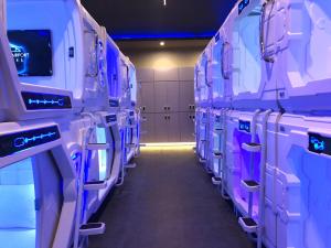 a aisle of an airplane aisle with purple and white stalls at Passgo Digital Airport Terminal 3 Soekarno Hatta in Tangerang +6 photos