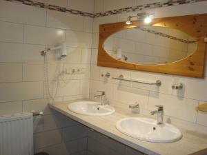 a bathroom with two sinks and a mirror at Einkehrhof Poggau in Reinsberg