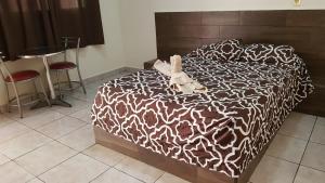 a dog laying on a bed in a room at Costa Miramar in Acapulco